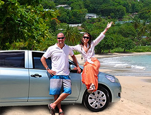 Visitors standing with a rental vehicle in Saint Lucia